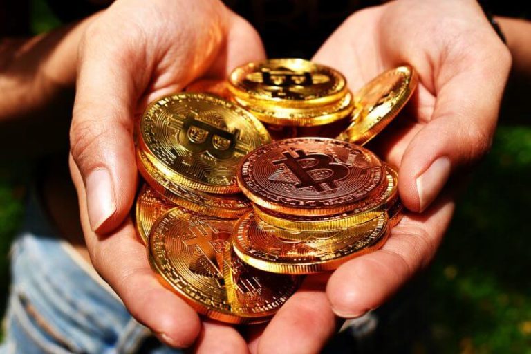 hand holding bitcoins